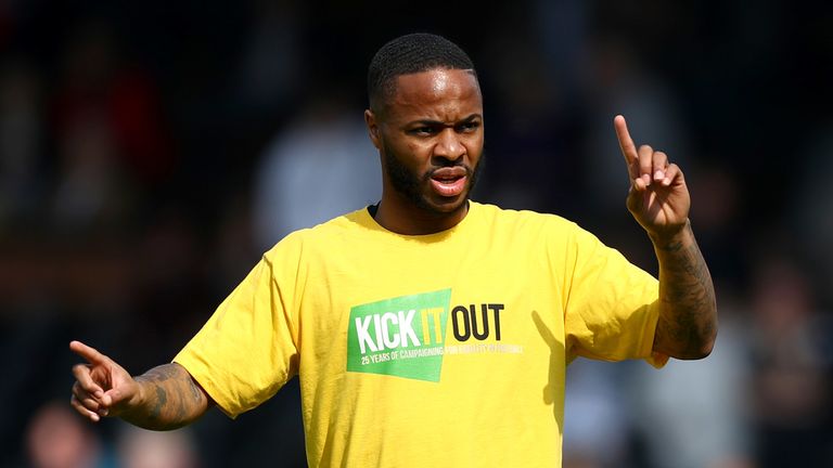 Raheem Sterling warms up for Manchester City wearing a 'Kick It Out' t-shirt