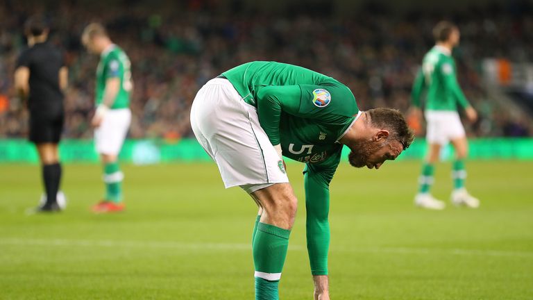 Republic of Ireland defender Richard Keogh removes balls which were thrown onto the pitch during Tuesday night's game