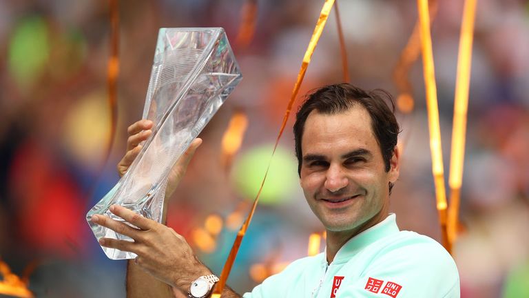 Roger Federer of Switzerland in celebrates with the winners trophy against John Isner of USA in the final during day fourteen of the Miami Open tennis on March 31, 2019 in Miami Gardens, Florida