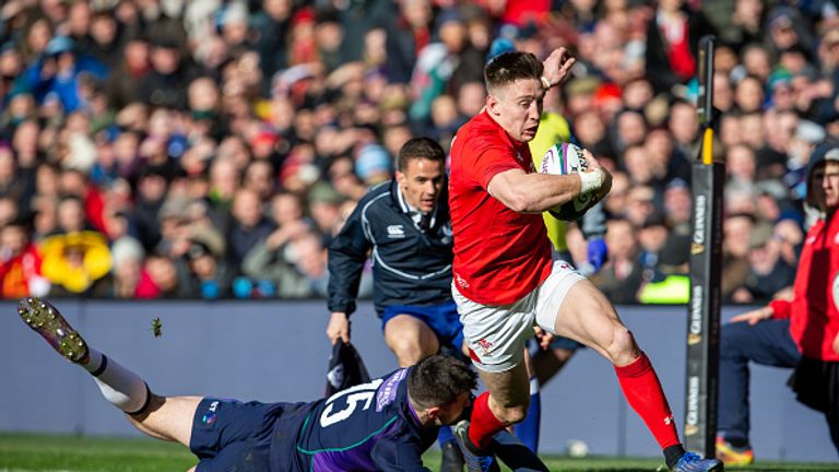 Josh Adams scores a try during Wales' win over Scotland