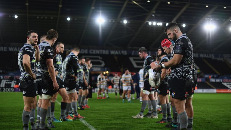 Members of the Ospreys side cut dejected figures after defeat to Worcester Warriors during the Challenge Cup match between Ospreys and Worcester Warriors at Liberty Stadium, Swansea.