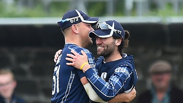 Scotland's Dylan Budge (R) and Scotland's Mark Watt celebrate taking the wicket of Pakistan's Sarfraz Ahmed (unseen) for 14 runs during the second Twenty20 International cricket match between Scotland and Pakistan at the Grange Cricket Club in Edinburgh, Scotland, on June 13, 2018