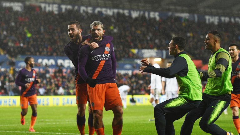 Sergio Aguero celebrates with Bernardo Silva after scoring Manchester City's winner against Swansea