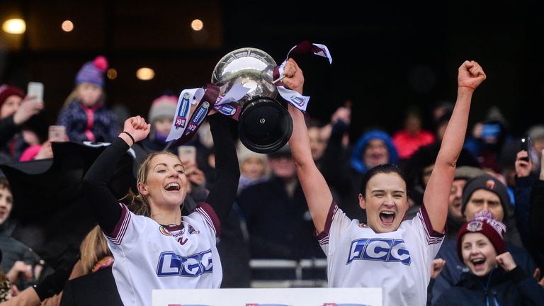 Gráinne O'Kane and Siobhán Bradley of Slaughtneil lift the trophy