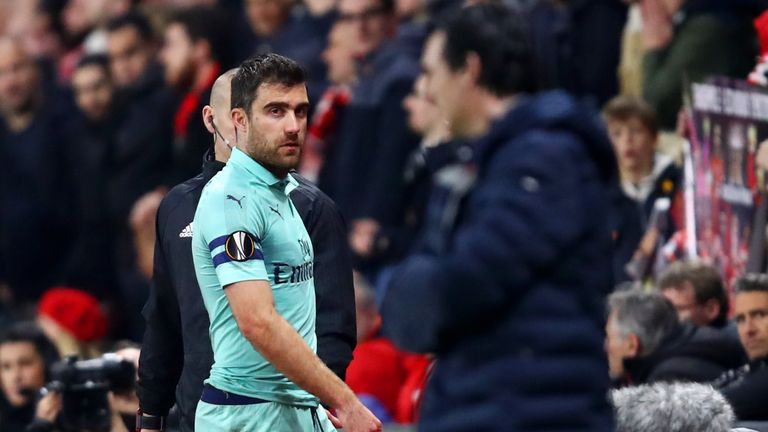 Sokratis Papastathopoulos walks off the pitch as he receives a red card in first half
