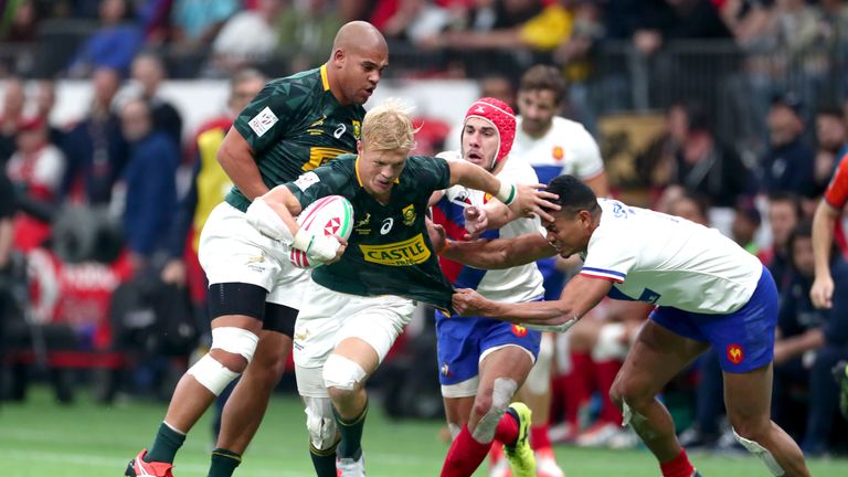 South Africa's JC Pretorius fights off a tackle from Remi Siega on Sunday