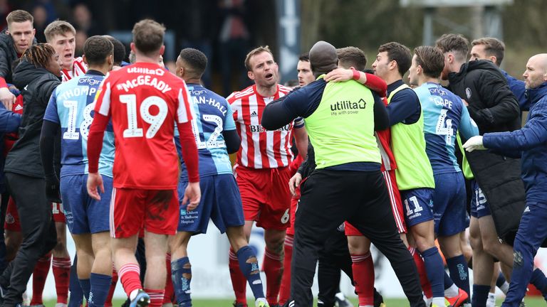 Lee Cattermole speaks to Adebayo Akinfenwa as tempers flare during the Sky Bet League One match between Wycombe Wanderers and Sunderland