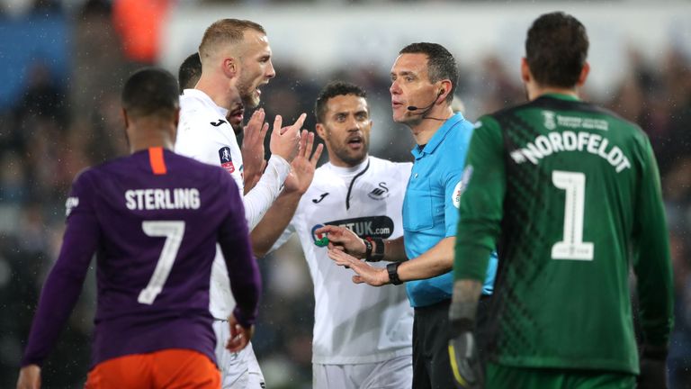 Swansea City's Mike van der Hoorn appeals to match referee Andre Marriner during the FA Cup quarter final match at the Liberty Stadium, Swansea. PRESS ASSOCIATION Photo. Picture date: Saturday March 16, 2019. See PA story SOCCER Swansea. Photo credit should read: Nick Potts/PA Wire. RESTRICTIONS: EDITORIAL USE ONLY No use with unauthorised audio, video, data, fixture lists, club/league logos or "live" services