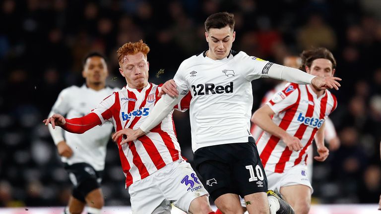 Stoke City's Ryan Woods (left) and Derby County's Tom Lawrence battle for the ball