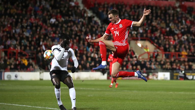 Trinidad and Tobago's Aubrey David (left) and Wales' Ryan Hedges (right) battle for the ball