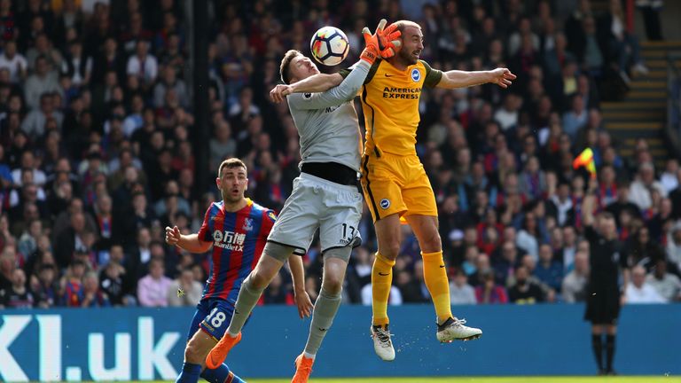 Wayne Hennessey of Crystal Palace competes for the ball with Glenn Murray of Brighton and Hove Albion during the Premier League match between Crystal Palace and Brighton and Hove Albion at Selhurst Park on April 14, 2018 in London, England