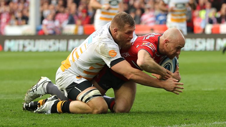  Willi Heinz scores a try for Gloucester despite the attentions of Brad Shields