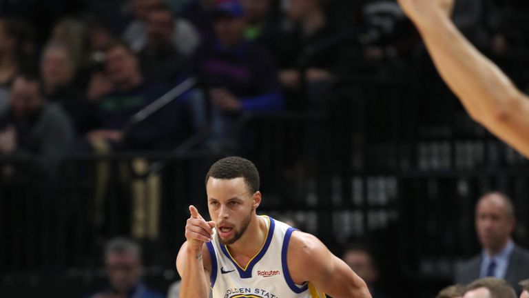 Stephen Curry acknowledges an assist after making a three-pointer