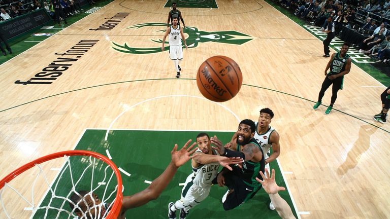 Kyrie Irving lofts a shot over the Bucks&#39; defense