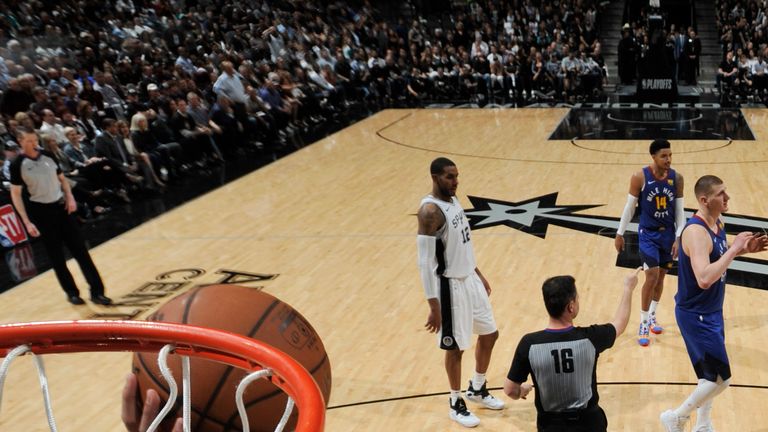 Derrick White scores at the rim during San Antonio's Game 3 win over Denver