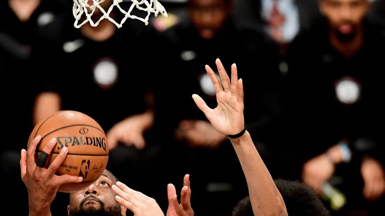 Dwyane Wade scores with a lay-up against Brooklyn