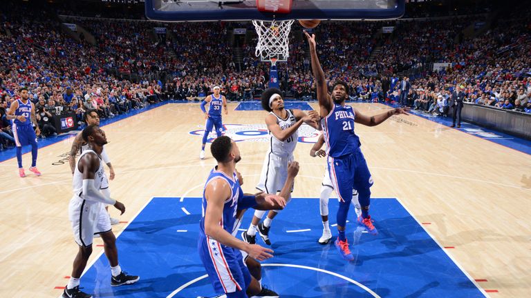 Joel Embiid lofts a finger roll over Jarrett Allen