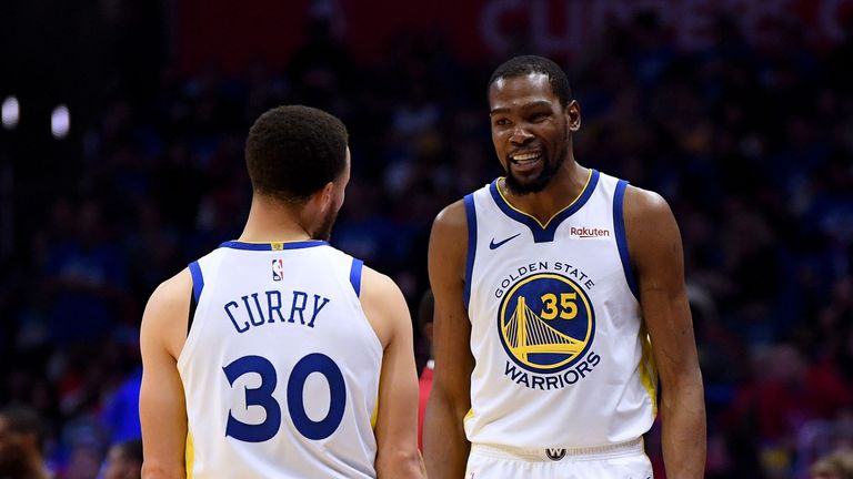 Stephen Curry congratulates Kevin Durant during the Golden State Warriors&#39; Game 3 win over the Los Angeles Clippers