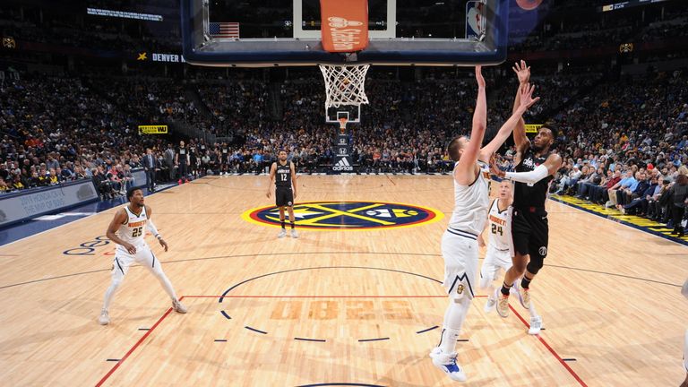 Troy Brown Jr shoots over the  Denver Nuggets defense