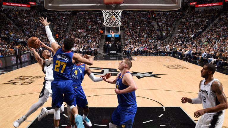 Derrick White shoots a fadeaway over Jamal Murray