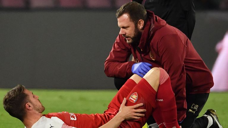 Aaron Ramsey receives medical attention on the pitch
