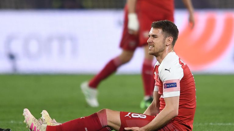 Aaron Ramsey of Arsenal holds his injured leg