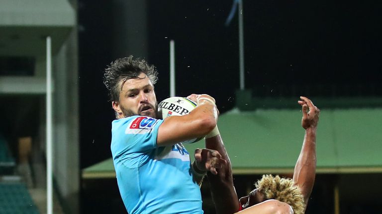 Waratahs' Adam Ashley-Cooper takes a high ball over Will Genia of the Rebels 