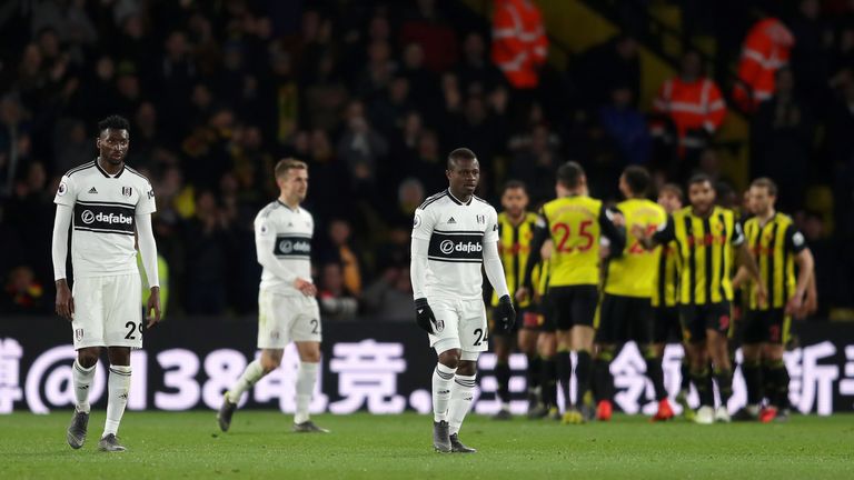 Fulham's Andre Zambo Anguissa and Jean Michael Seri look dejected as Watford celebrate scoring