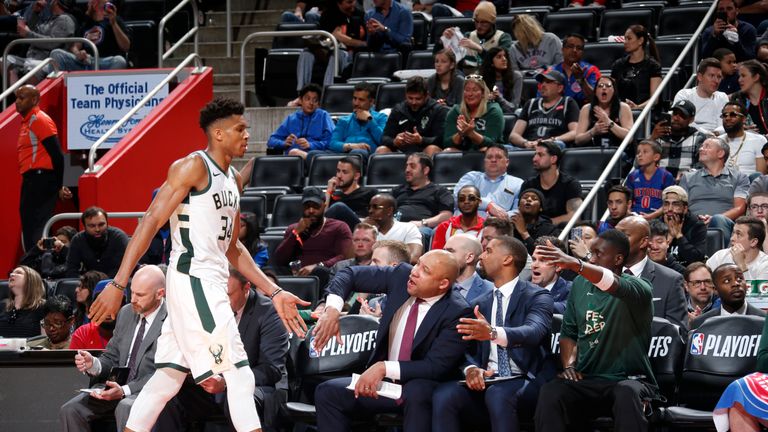 Giannis Antetokounmpo of the Milwaukee Bucks high fives his coaches and teammates during Game Four of Round One of the 2019 NBA Playoffs against the Detroit Pistons