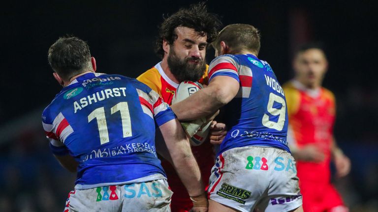 Antoni Maria is tackled by Wakefield's Kyle Wood and Matty Ashurst