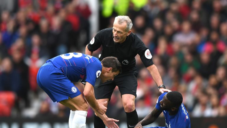 Antonio Rudiger goes down holding his left knee during the 1-1 draw with Manchester United at Old Trafford