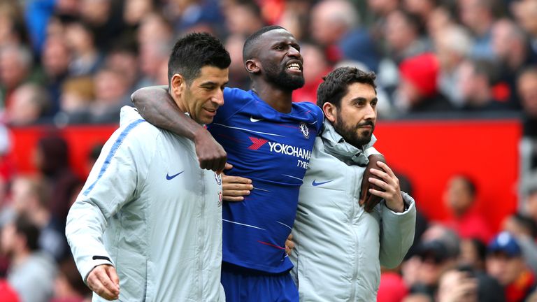 Chelsea defender Antonio Rudiger is helped off injured in Chelsea's Premier League game with Manchester United at Old Trafford