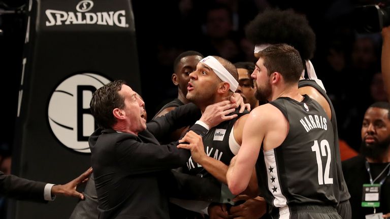 Head coach Kenny Atkinson and Joe Harris of the Brooklyn Nets hold back Jared Dudley at Barclays Center after a foul by Joel Embiid of the Philadelphia 76ers in the third quarter