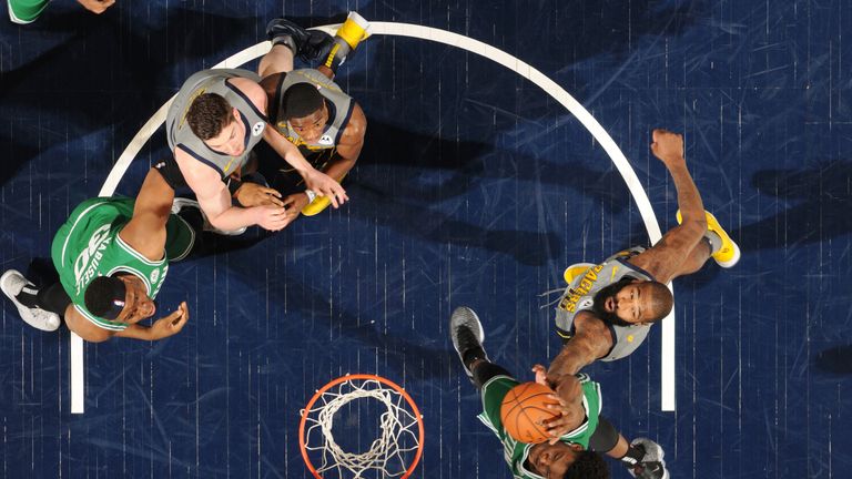 Robert Williams III of the Boston Celtics goes to the basket against Kyle O&#39;Quinn #10 of the Indiana Pacers