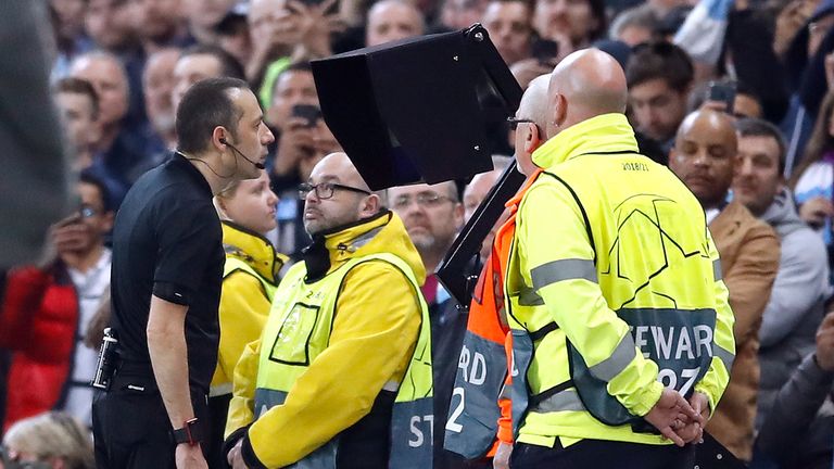 Referee Cuneyt Cakir checks VAR during Champions League quarter-final tie between Manchester City and Tottenham Hotspur at Etihad Stadium