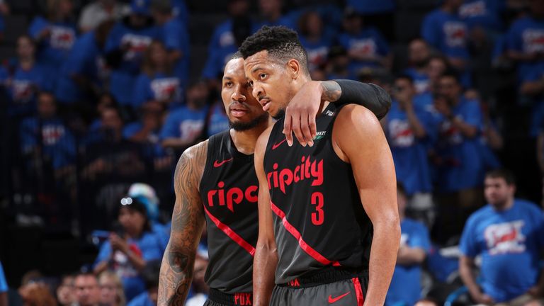 Damian Lillard #0 and CJ McCollum #3 of the Portland Trail Blazers look on during Game Four of Round One of the 2019 NBA Playoffs on April 21, 2019 at Chesapeake Energy Arena in Oklahoma City, Oklahoma.