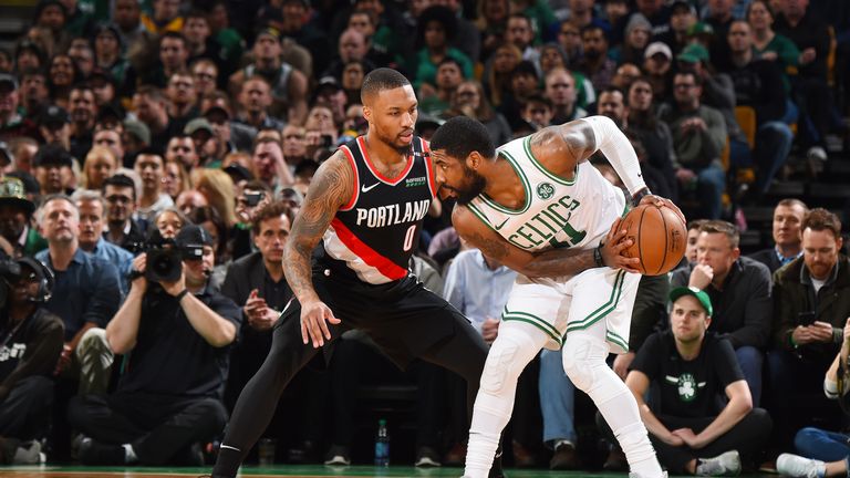 Kyrie Irving #11 of the Boston Celtics guards the ball during the game against Damian Lillard #0 of the Portland Trail Blazers on February 27, 2019 at the TD Garden in Boston, Massachusetts.