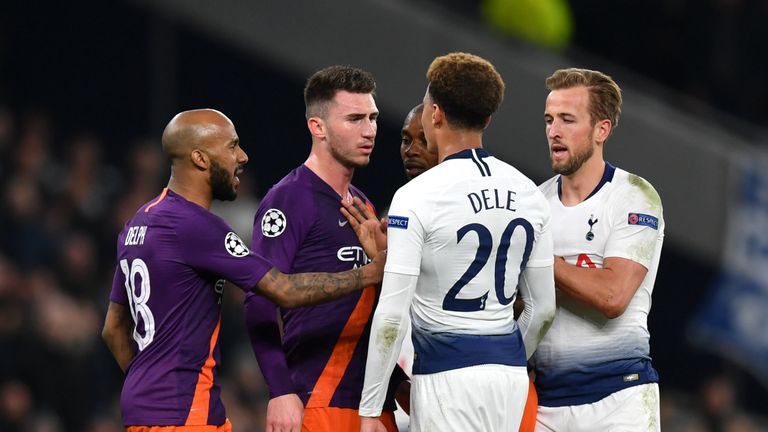 Dele Alli of Tottenham Hotspur clashes with Aymeric Laporte of Manchester City