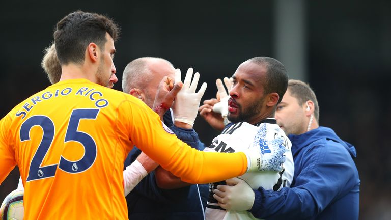 Denis Odoi of Fulham is given treatment after a collision with a team mate during the Premier League match between Fulham FC and Cardiff City at Craven Cottage on April 27, 2019