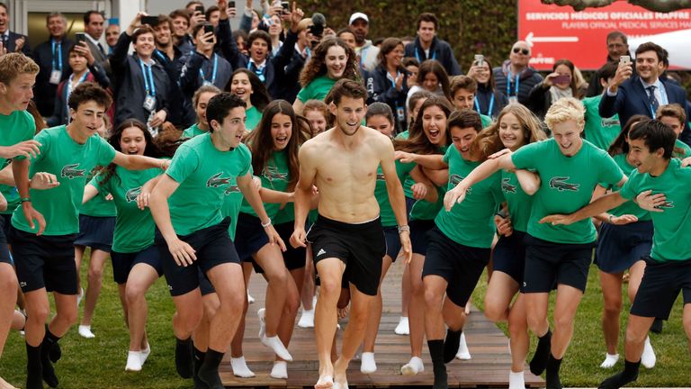 Austria's Dominic Thiem runs with ballboys and ballgirls prior to jumping into a pool as he celebrates defeating Russia's Daniil Medvedev during the ATP Tour Barcelona Open final tennis match in Barcelona on April 28, 2019.
