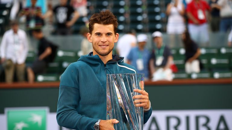 Dominic Thiem of Austria holds the championship trophy after his men's singles final victory against Roger Federer of Switzerland on day fourteen of the BNP Paribas Open at the Indian Wells Tennis Garden on March 17, 2019 in Indian Wells, California