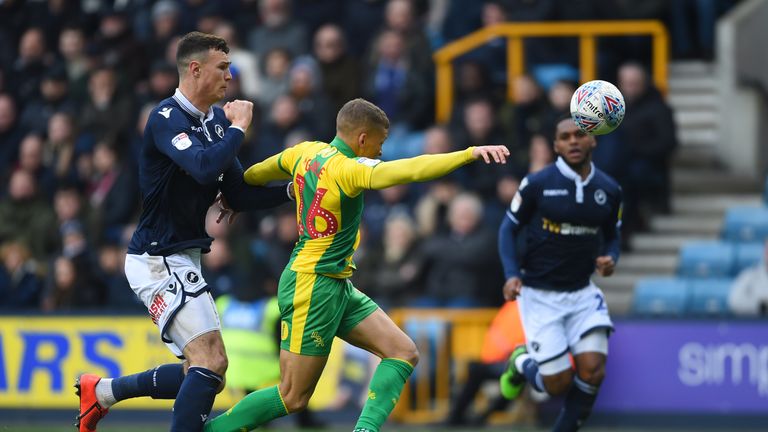 Dwight Gayle is fouled by Jake Cooper for a West Brom penalty at Millwall