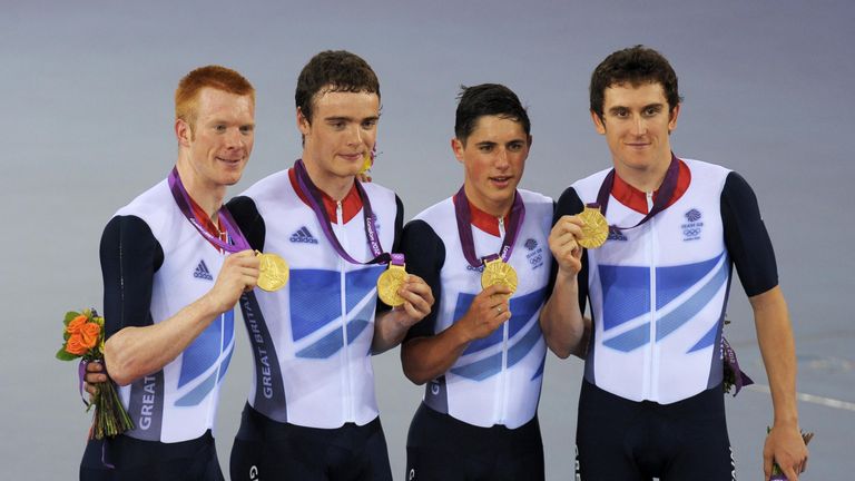 Great Britain's Ed Clancy (left), Geraint Thomas (right), Steven Burke (second left) and Peter Kennaugh celebrate with their Gold medals in the Men's Team Pursuit Final during day seven of the Olympic Games at the Velodrome, London.