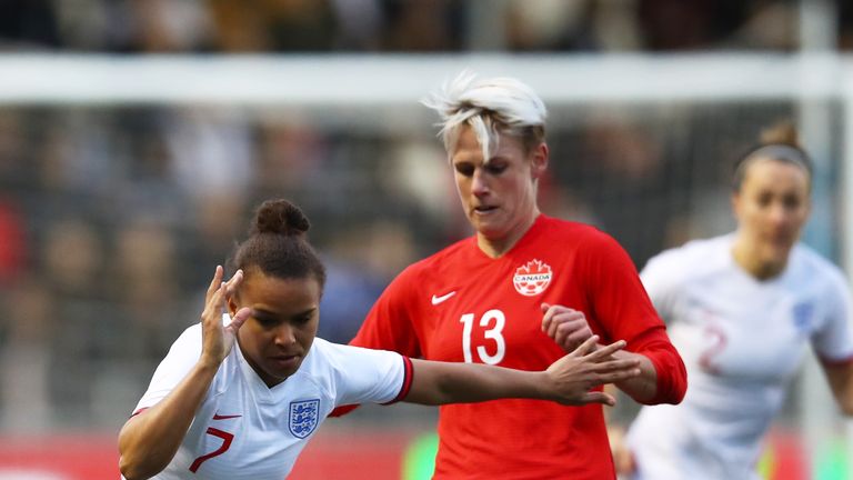 Nikita Parris views for the ball with Sophie Schmidt for England Women against Canada