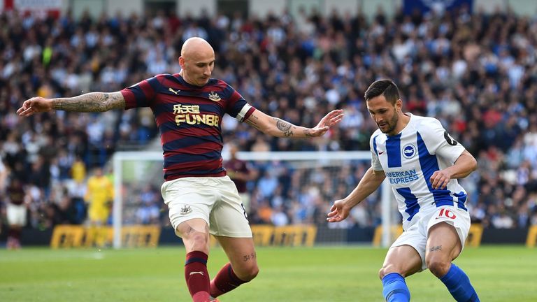 Florin Andone takes on Jonjo Shelvey at the AMEX Stadium