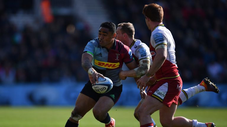 Francis Saili of Harlequins hands off the ball 
