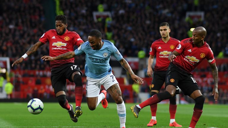 Fred battles for possession with Raheem Sterling