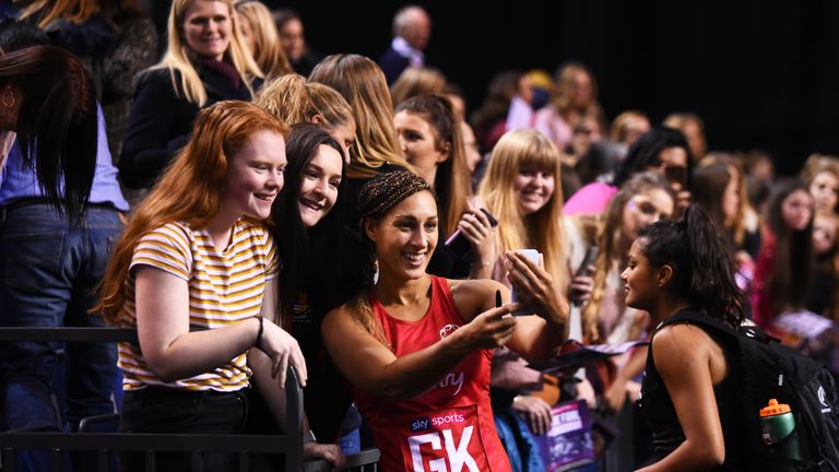 Geva Mentor poses with fans after an international match