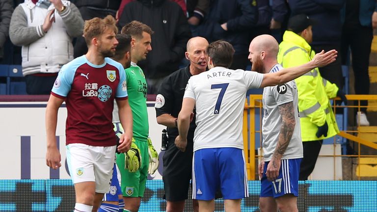Harry Arter and Aron Gunnarsson remonstrate with referee Mike Dean following an appeal for a penalty at Turf Moor