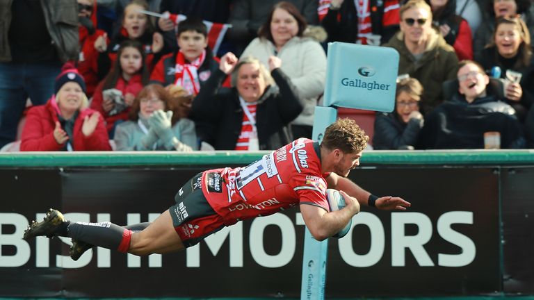 Henry Purdy of Gloucester dives in for a try